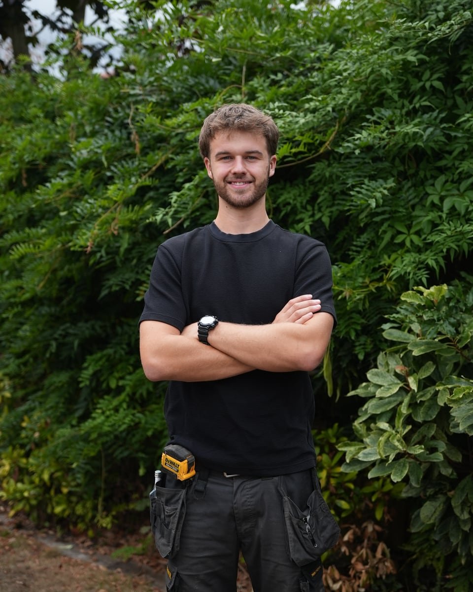 Sam Bullen in workwear with his landscaping tools